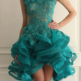 Teal lace dress with ruffled skirt on a neutral background