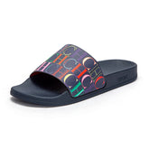 Black slide sandal with colorful logo pattern on a white background