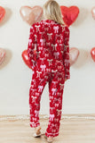 Person wearing a red outfit with pink bows in front of heart-shaped balloons.