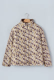 Long-sleeve brown, beige, and white abstract organic pattern quilted jacket on hanger against light gray.