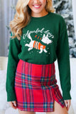Woman in dark green “colourful days” dog-print sweater with red-green plaid mini skirt.