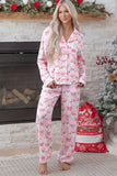 Woman in pink long-sleeve pajamas with Santa and snowman print.
