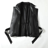 Black leather vest with straps on a white background