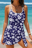 Woman wearing a navy blue floral dress with a beach background