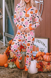 Woman in Halloween basketball-print pajamas by a pumpkin-decorated barn door.