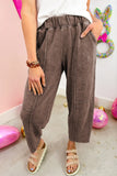 Person wearing brown pants with a colorful background