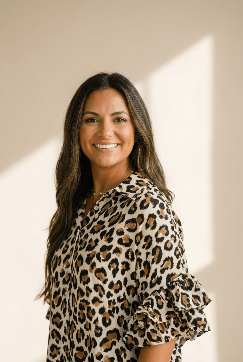 Woman wearing a leopard print blouse against a neutral background