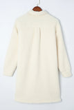 Off-white sherpa fleece shirt jacket with long sleeves on a wooden hanger.