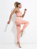 Woman wearing a pink athletic outfit on a white background