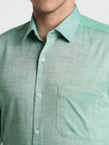Close-up of a green checkered shirt with a collar and buttons.