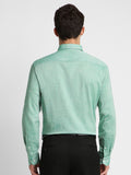 Man wearing a light green checkered shirt on a white background