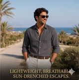 Man wearing sunglasses and a gray shirt standing on a sun-drenched path with palm trees and ocean in the background.