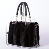 Black fur handbag with gold accents and measurements on a white background