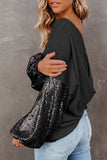 Woman wearing a black sweater with sequin sleeves against a gray background