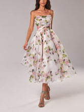Woman wearing a floral dress on a plain background