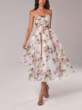 Woman wearing a floral dress on a plain background