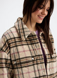 Woman wearing a plaid coat on a white background