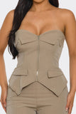 Beige strapless top with a zipper and layered design on a white background
