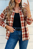 Woman wearing a plaid shirt, black top, and blue jeans against a light wooden panel background.