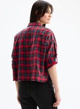 Person wearing a red and black plaid shirt on a white background