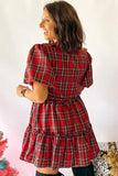 A woman wearing a red and black plaid puff-sleeve mini dress, shown from the back against a plain white background.