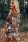 Woman wearing a plaid jacket in a forest setting