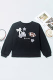 Black sweatshirt with white bow, football, and star graphics, styled flat with a tennis racket.
