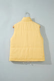 A pale yellow quilted puffer vest hanging on a metal hanger against a light gray background.