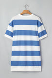 Blue and white striped dress on a hanger against a gray background