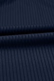 Close-up of dark navy ribbed fabric with a fine vertical stripe texture and a horizontal fold.