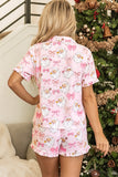 Back view of woman in pink Santa and bow print pajamas.