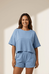 Woman wearing a blue outfit on a beige background