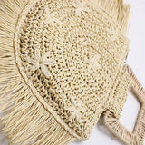 Beige woven bag with fringe details on a white background