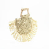 Beige woven handbag with fringe details on a white background