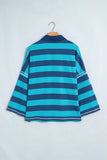 Navy-turquoise striped mock-neck top with solid navy collar on hanger.