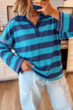 Mirror selfie of person in navy-turquoise striped polo shirt and light-wash jeans.