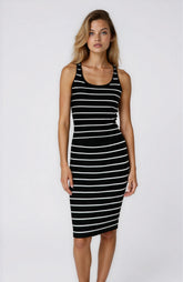 Woman wearing a black and white striped dress on a white background