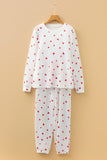White pajama set with red heart patterns on a beige background