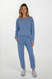 Woman wearing a blue outfit with a plain background
