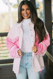 Woman wearing a pink and white jacket with a blurred outdoor background