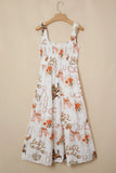 White dress with floral and ribbon pattern on a beige background