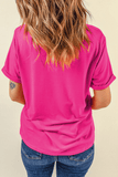 Person wearing a bright pink t-shirt and blue jeans on a beige background