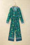 Teal green candy cane pajamas with collared top and wide-leg pants on hanger.