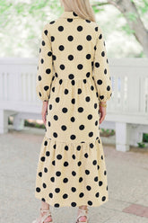 Back view of apricot and black polka dot tiered long sleeve maxi dress
