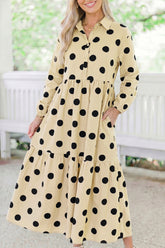Woman in apricot polka dot button front tiered long sleeve maxi dress with hand in pocket