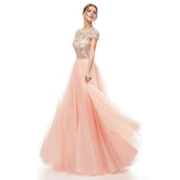 Woman wearing a pink evening gown with beaded top on a white background
