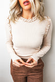 Beige ribbed long sleeve top with frill trim neckline and shoulders, front view
