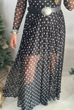 Sheer polka dot mesh maxi dress over black slip, styled with a silver buckle belt