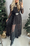 Woman in black polka dot mesh mock neck maxi dress with buckle belt and ankle boots, selfie