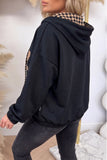 Black PRAY graphic hoodie, back view showing plaid-lined hood